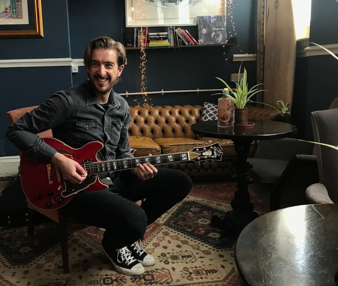 Andy playing his signature acoustic guitar